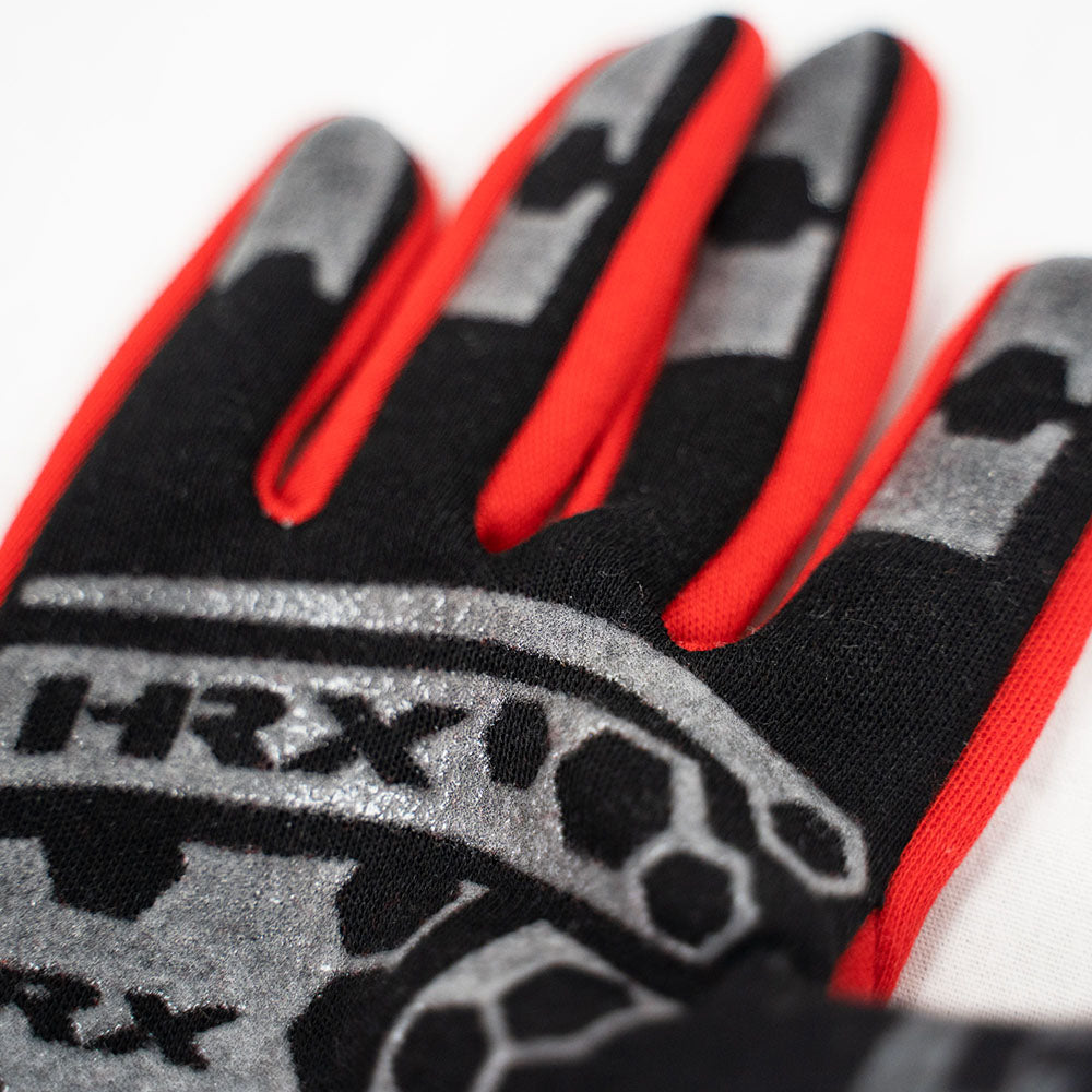 Close-up of a glove with red, black, and gray design on a white background