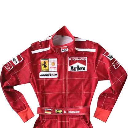 Close-up of Schumacher’s 1996 F1 suit, featuring the detailed stitching, Ferrari red color, and early sponsor branding from his debut season