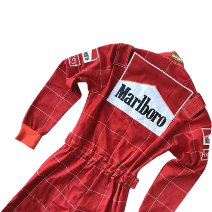 Backside of Schumacher’s 1996 race suit, showcasing Ferrari red and white design with classic sponsor patches, marking his first season