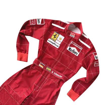 Close-up of Schumacher’s 1996 F1 suit, featuring the detailed stitching, Ferrari red color, and early sponsor branding from his debut season