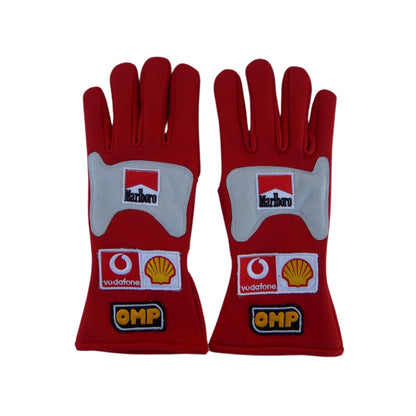 Red Michael Schumacher 2006 F1 Racing gloves with multiple brand logos on a white background