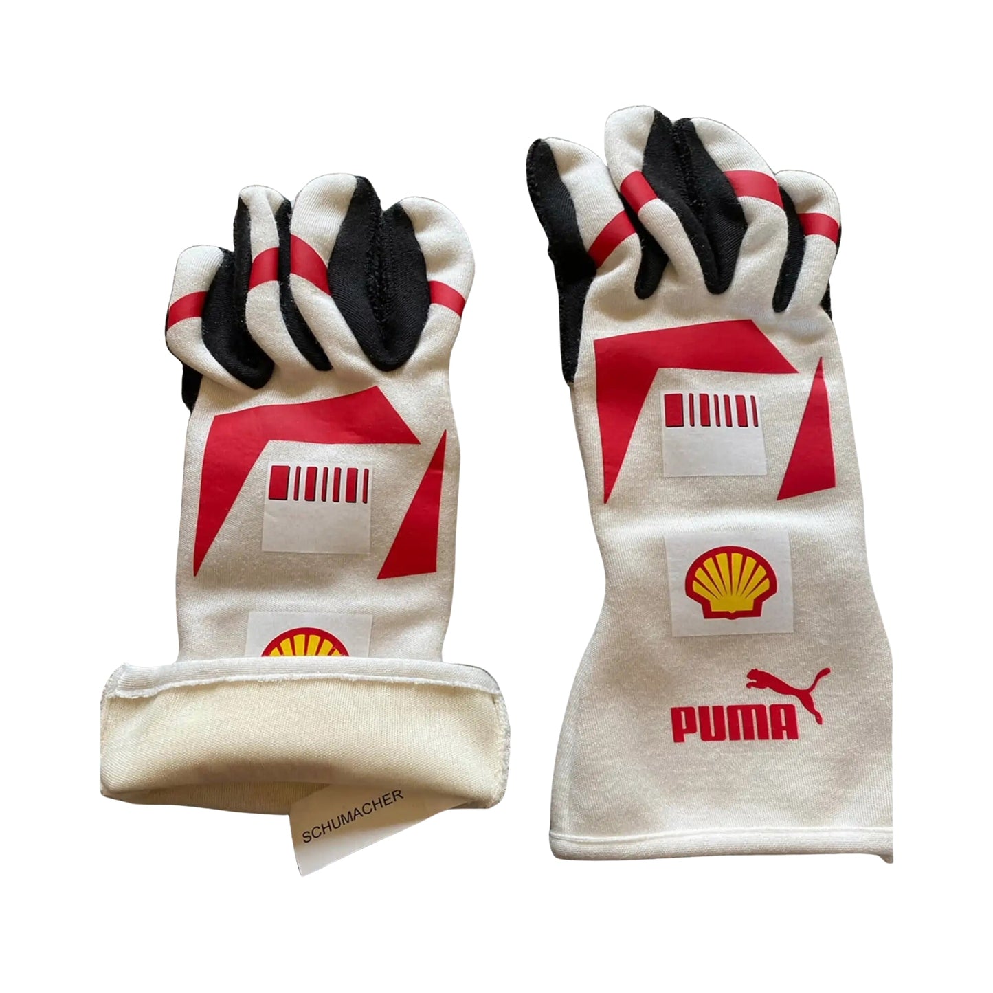 Pair of white Michael Schumacher 2007 F1 racing gloves with red and black accents featuring Puma and Shell logos on a white background.