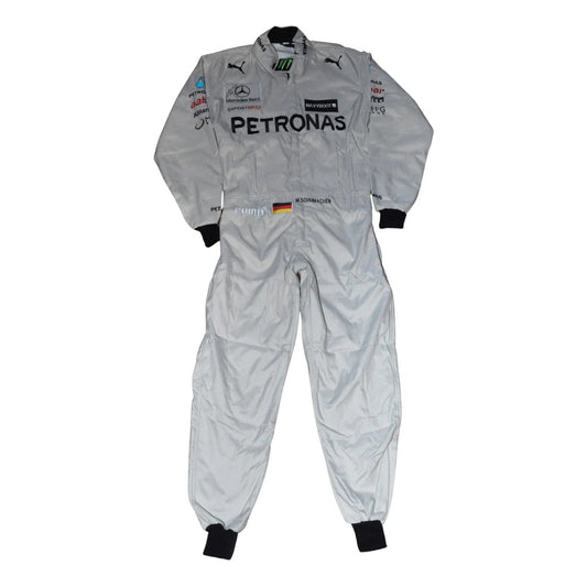 Front view of the 2012 Michael Schumacher F1 racing suit, featuring a silver base with black and green accents, and stitched sponsor panels across the chest.