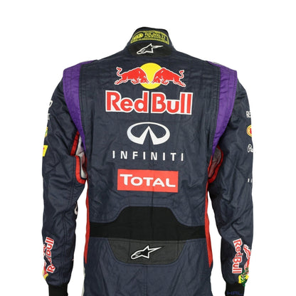 Back view of the 2014 racing suit worn by Sebastian Vettel, showcasing a bold deep blue base with red and yellow design highlights.