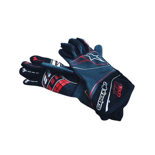 Pair of black Lando Norris 2016 F1 gloves with red and white accents on a white background