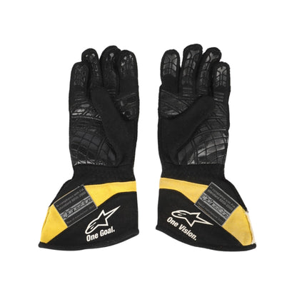 Black and yellow Carlos Sainz 2017 F1 racing gloves with branding on a white background