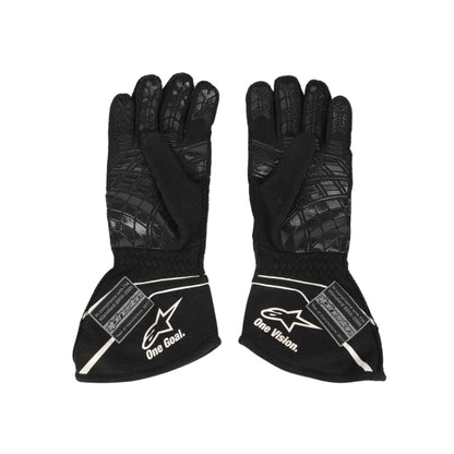 Pair of black Nico Hulkenberg 2017 F1 racing gloves with visible branding on a white background