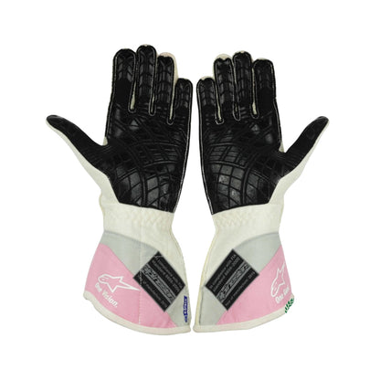 Pair of black and white Lance Stroll 2019 F1 Racing gloves with pink accents on a white background