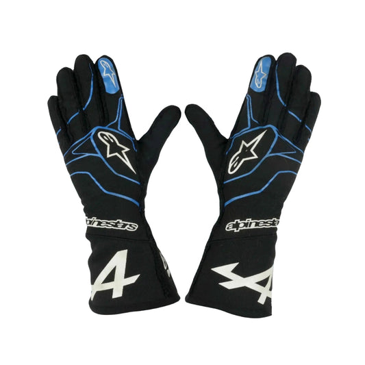 Black Fernando Alonso 2021 F1 racing gloves with blue accents and Alpinestars logo on a white background