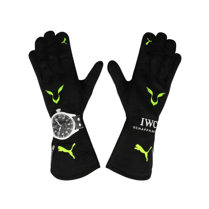 Black Lewis Hamilton 2022 F1 Racing gloves with green accents and a watch on a white background