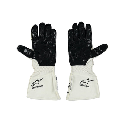 Pair of black and white Nyck de Vries 2022 F1 racing gloves with visible branding on a white background