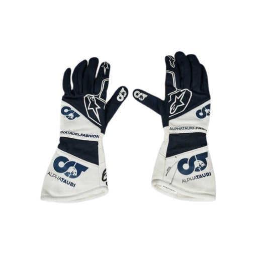 Pair of black and white Yuki Tsunoda 2022 F1 Racing gloves with branding on a white background