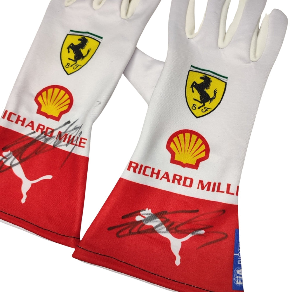 Pair of white Charles Leclerc 2023 Monaco GP F1 Racing gloves with Ferrari, Shell, and Richard Mille logos on a white background