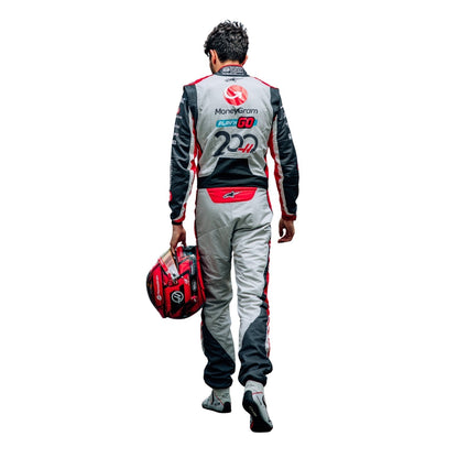 Back View of Esteban Ocon wearing a racing suit with visible branding on a white background