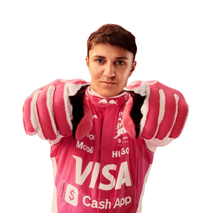 Isack Hadjar posing in his 2025 F1 race suit before the Miami Grand Prix, looking composed and race-ready.