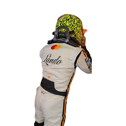 Rear view of the Monaco GP 2025 white race suit worn by Norris showcasing plain white tailored design, driver name badges, and subtle sponsor patches.