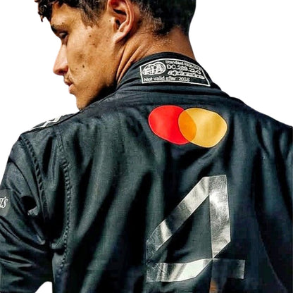 Lando Norris 2025 Silverstone papaya racing suit back profile showing sponsor and number layout, wearing a black racing suit with Mastercard and Visa logos on the back