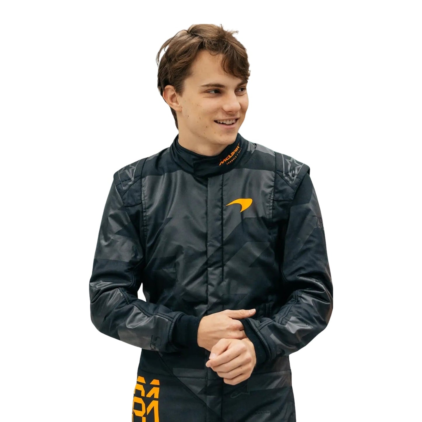 Close-up of Piastri with a —contrasting the matte black suit.