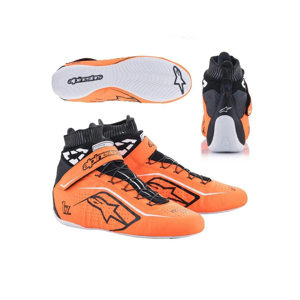 Orange and black Alpinestars Tech1-Zv2 racing shoes with white soles on a white background
