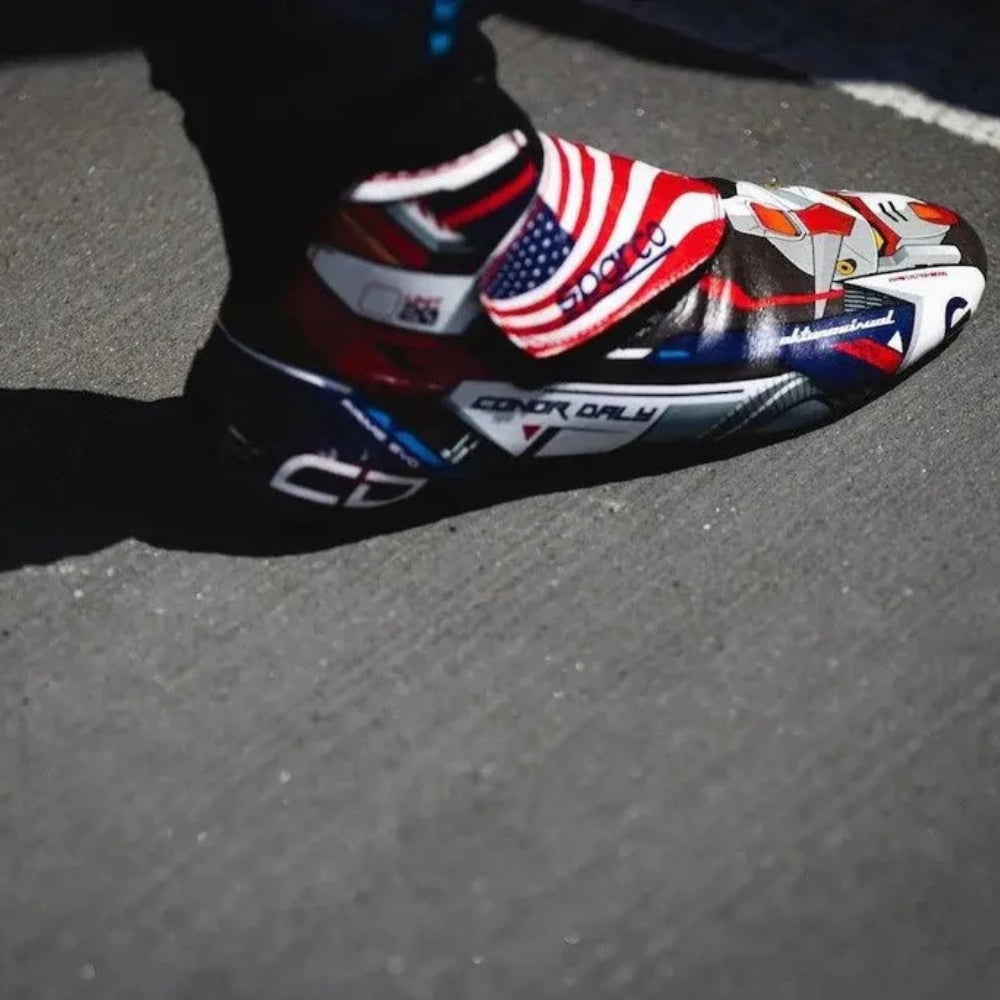Colorful Conor Daly 2022 IndyCar Racing shoe with American flag design on a gray surface