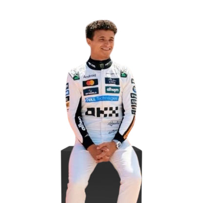 Lando Norris wearing a McLaren 2025 Monaco F1 racing suit with various sponsor logos on a white background