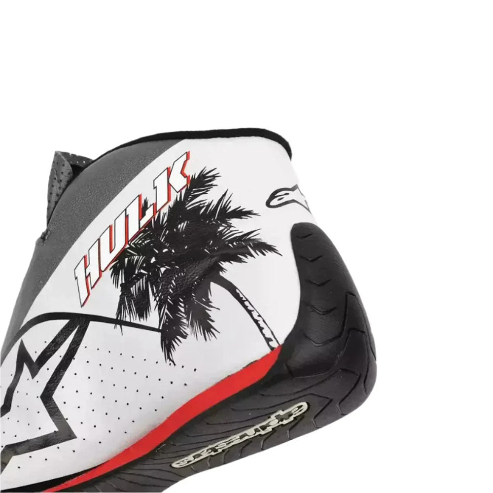 Close-up of a Nico Hulkenberg 2023 Miami GP Weekend Worn F1 Racing Shoes with palm tree design and 'Huk' branding on a white background