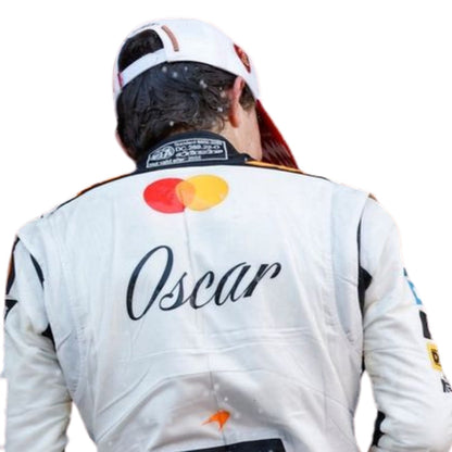 Oscar Piastri wearing a McLaren Monaco GP 2025 F1 racing suit with 'Mastercard' and 'Oscar' branding on a white background