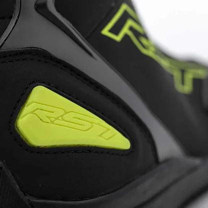 Close-up of a black and yellow Sabre Moto Racing shoes with 'RST' branding.